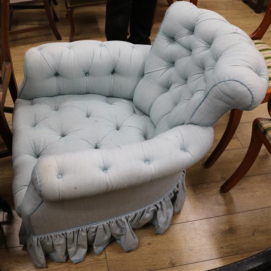 An upholstered button back armchair